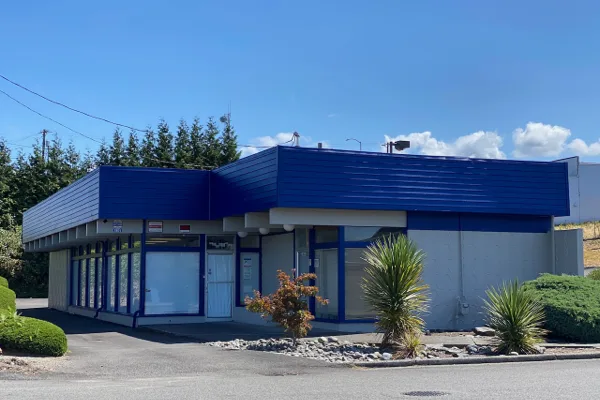 Exterior of the blue-trimmed building at 3801 South Puget Sound Avenue