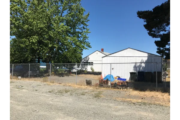 Building and fenced yard shown for 3835 South Puget Sound Avenue