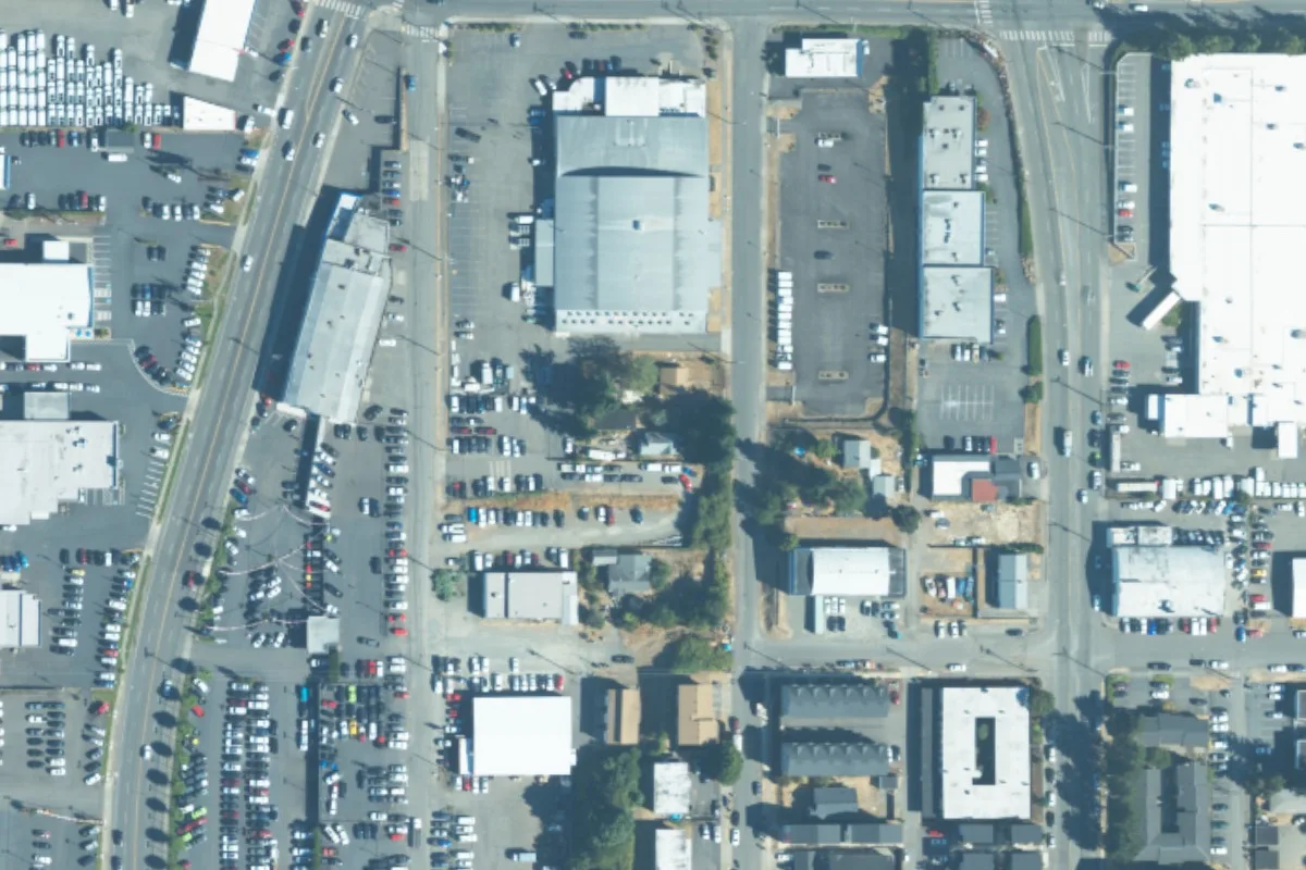 August 2023 aerial view around 3836 South Puget Sound Ave, with a green pin locating the house and rear garage
