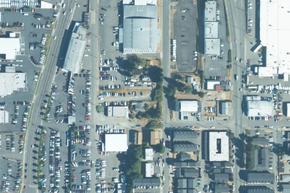 August 2023 aerial view around 3840 South Puget Sound Ave, with a green pin locating the vehicle lot