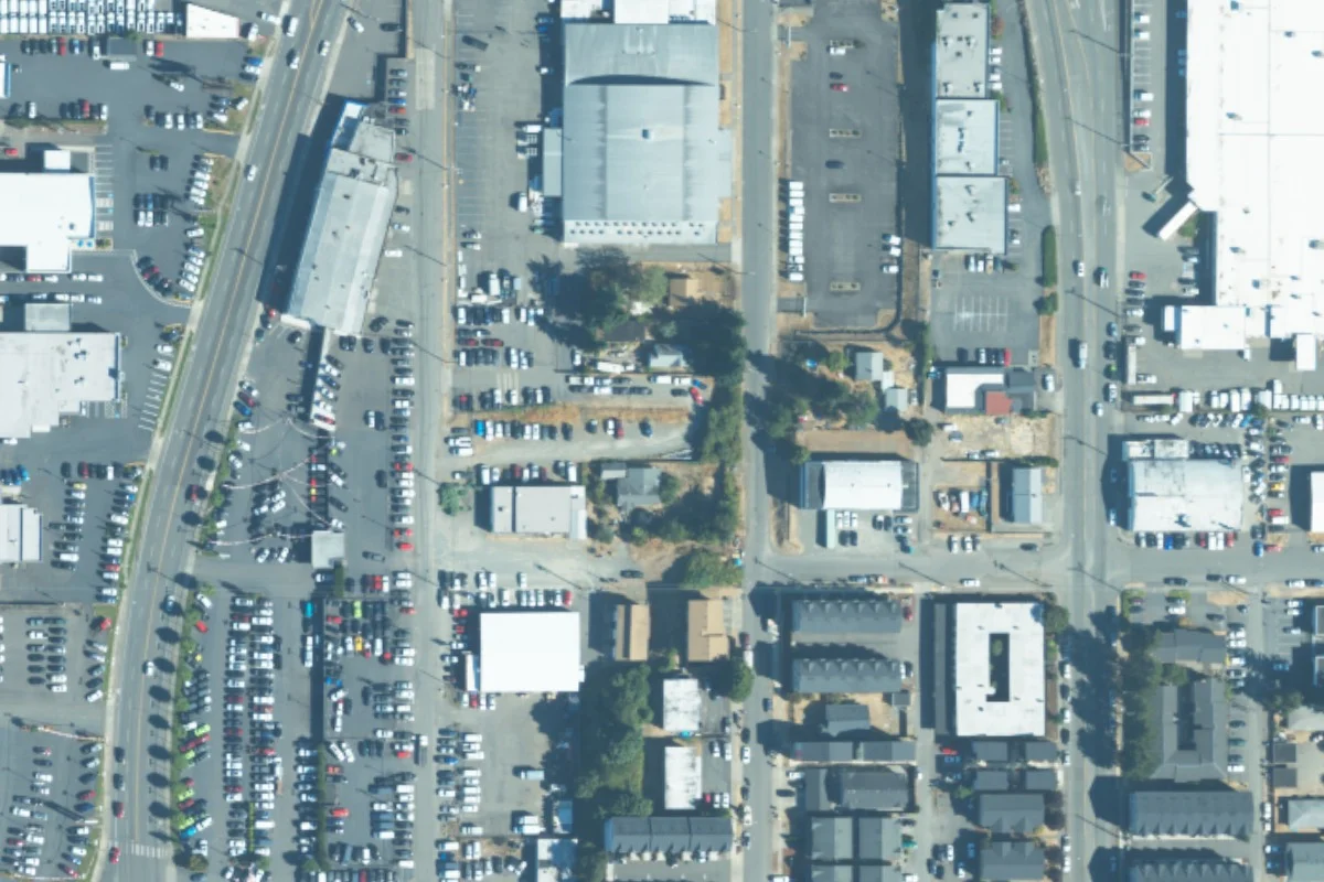 August 2023 aerial view around 3840 South Puget Sound Ave, with a green pin locating the vehicle lot